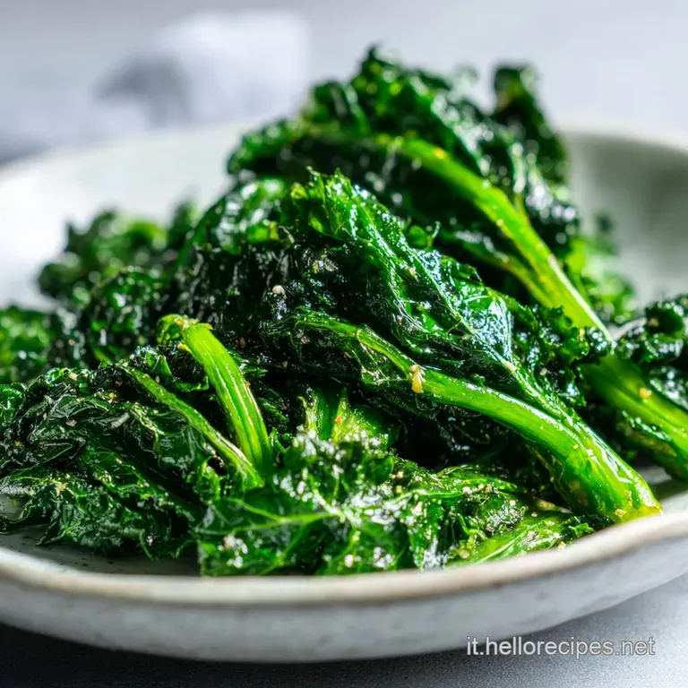 Cavolo nero piled high on a rustic plate, steam rising, showing the tender leaves and crispy garlic.