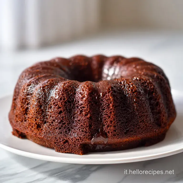 Slice of pear and chocolate cake on a white plate, the pear slices caramelized, dark chocolate chunks visible, inviting a ...